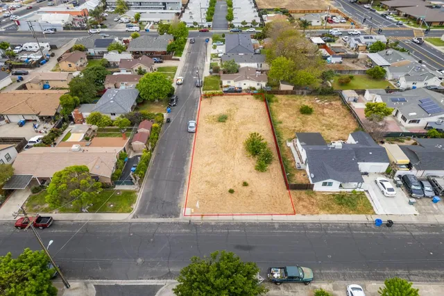 an aerial view of residential houses with outdoor space