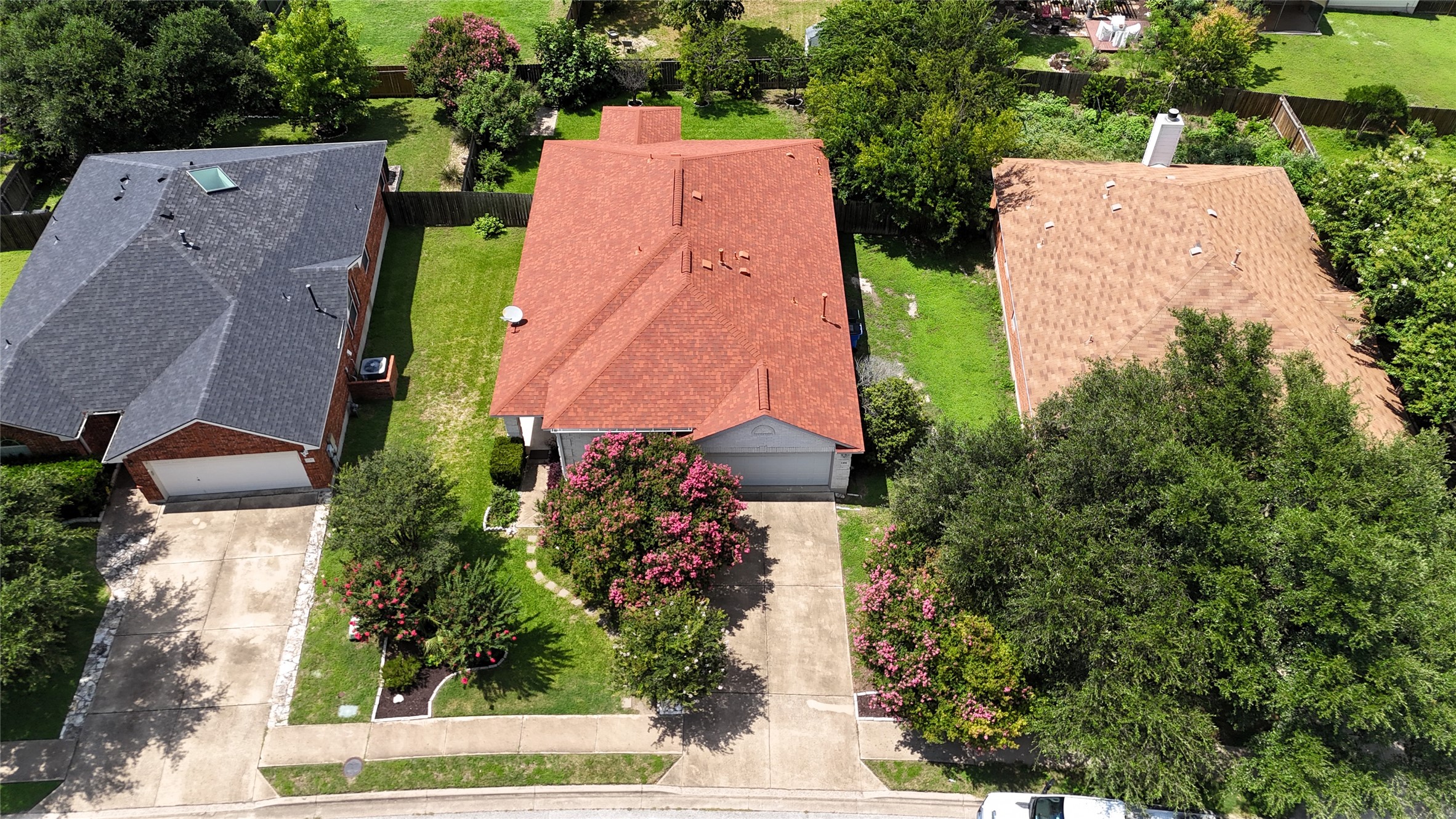 1108 Springbrook Road Pflugerville, TX 78660 - Photo 37 of 37 An aerial perspective reveals a well-maintained property featuring lush landscaping and a classic asphalt roof.