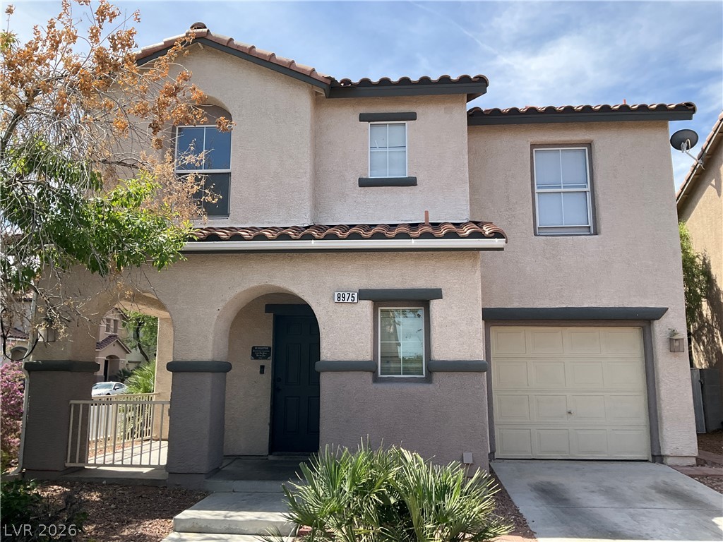 8975 Spring Peeper Avenue Las Vegas, NV 89148 - Photo 1 of 1 A charming two-story home with a distinctive arched entryway and attached garage.