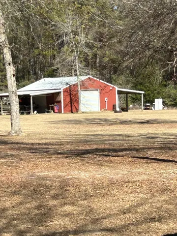 a view of a wooden house with a yard