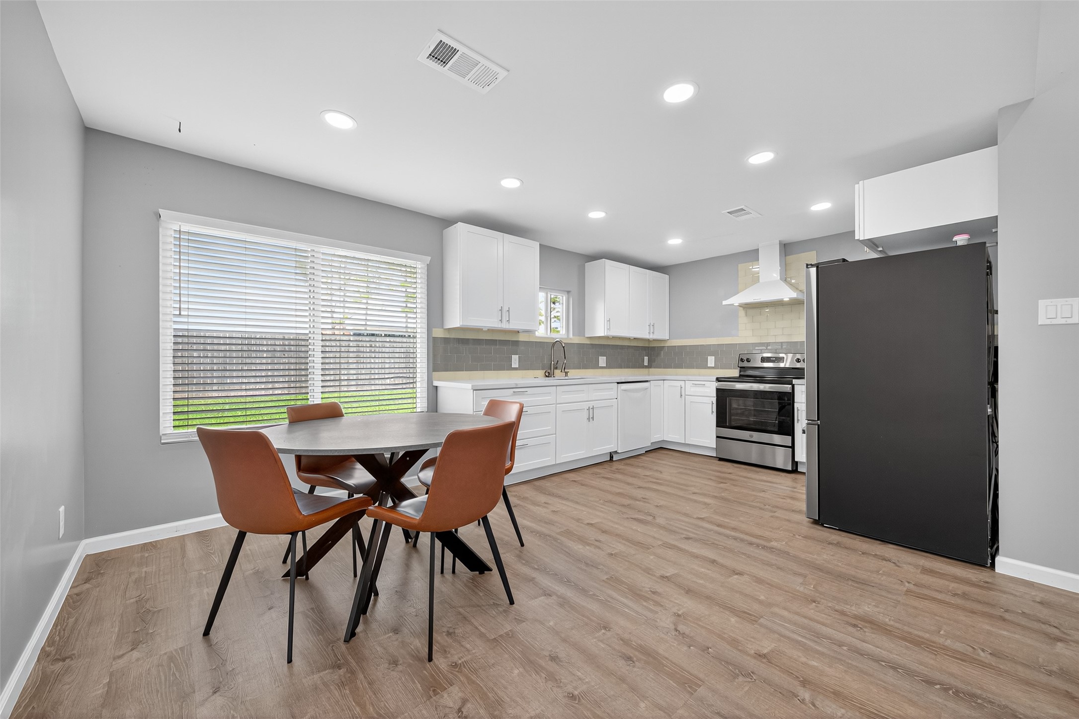 10106 Shadow Pine Drive Houston, TX 77070 - Photo 16 of 39 a kitchen with a table chairs refrigerator and microwave