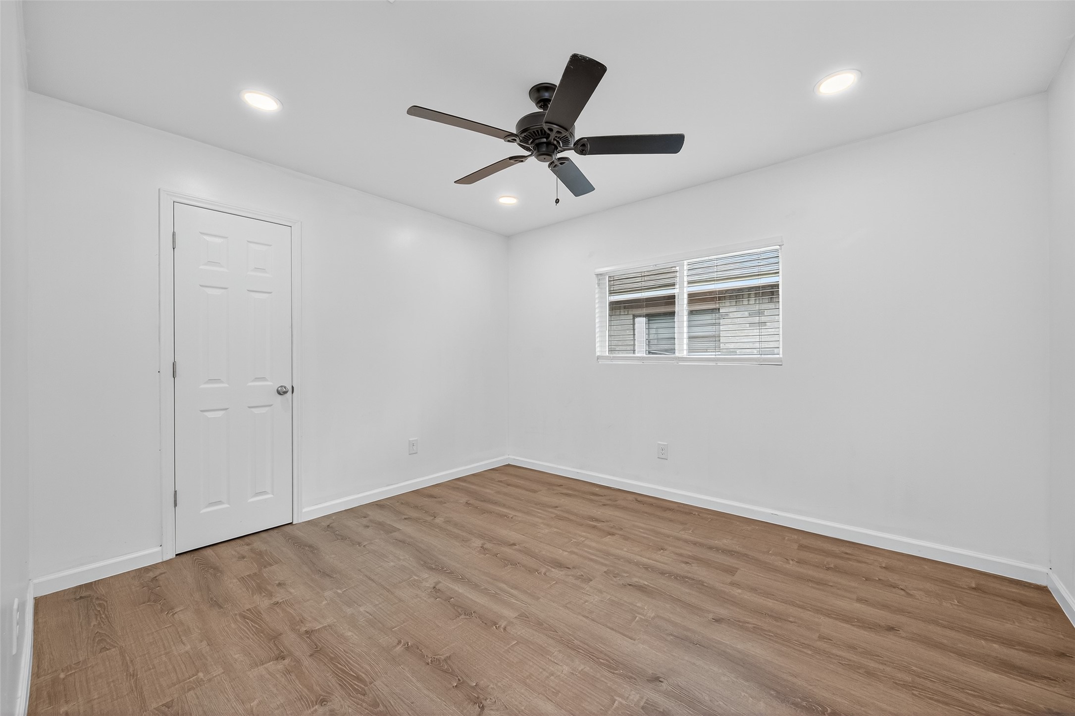 10106 Shadow Pine Drive Houston, TX 77070 - Photo 24 of 39 a view of an empty room with wooden floor and a ceiling fan