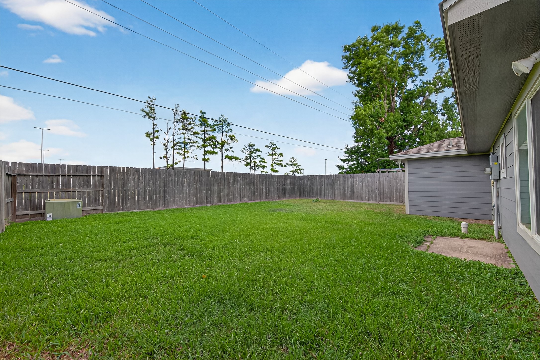 10106 Shadow Pine Drive Houston, TX 77070 - Photo 33 of 39 a view of a backyard with a large tree and wooden fence