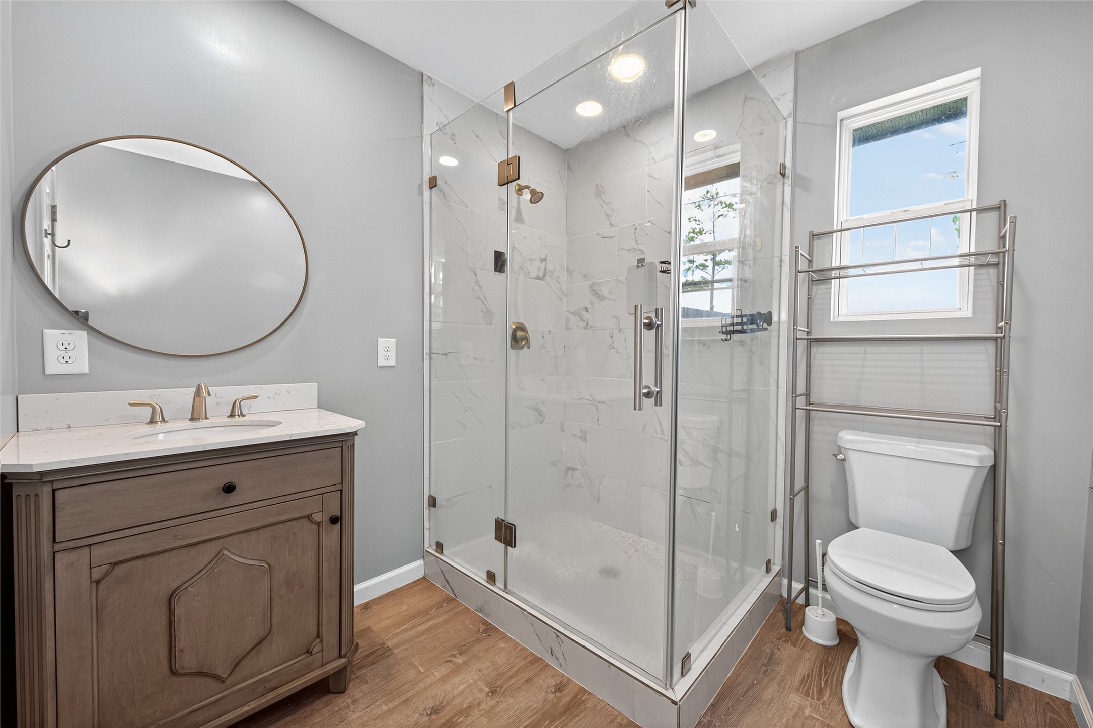 10106 Shadow Pine Drive Houston, TX 77070 - Photo 36 of 39 a bathroom with a toilet a sink a mirror a vanity and shower