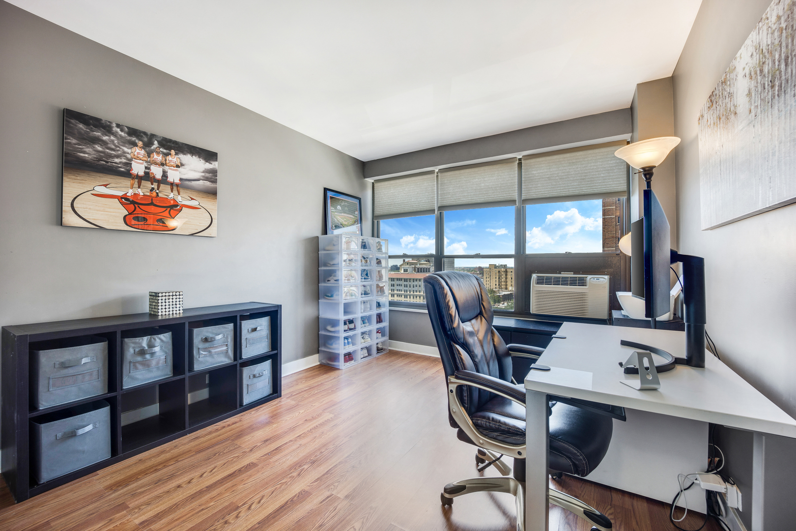 2930 North Sheridan Road, Unit 1401 Chicago, IL 60657 - Photo 11 of 23 a workspace with furniture and a book shelf