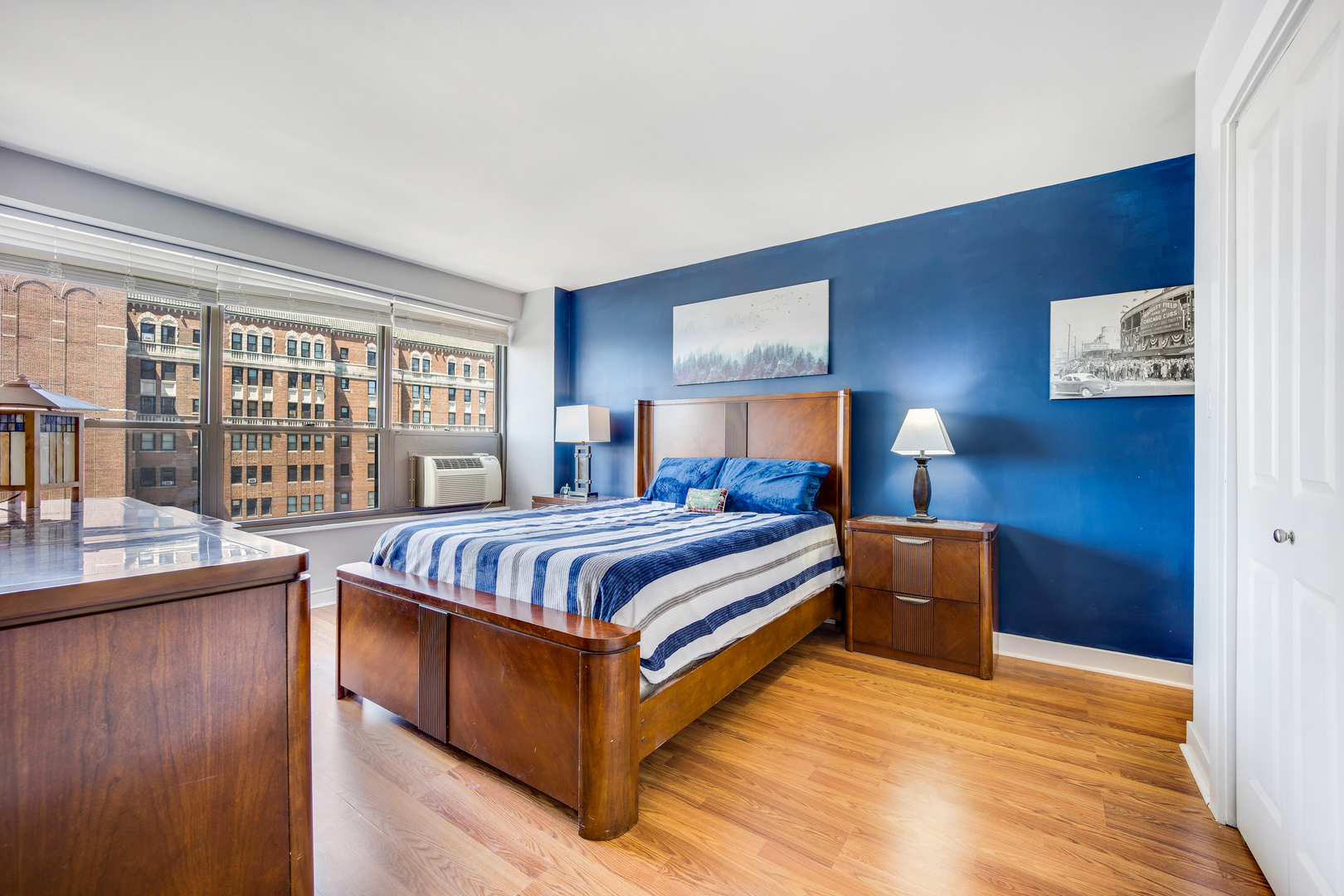 2930 North Sheridan Road, Unit 1401 Chicago, IL 60657 - Photo 12 of 23 a bedroom with a bed and a night stand