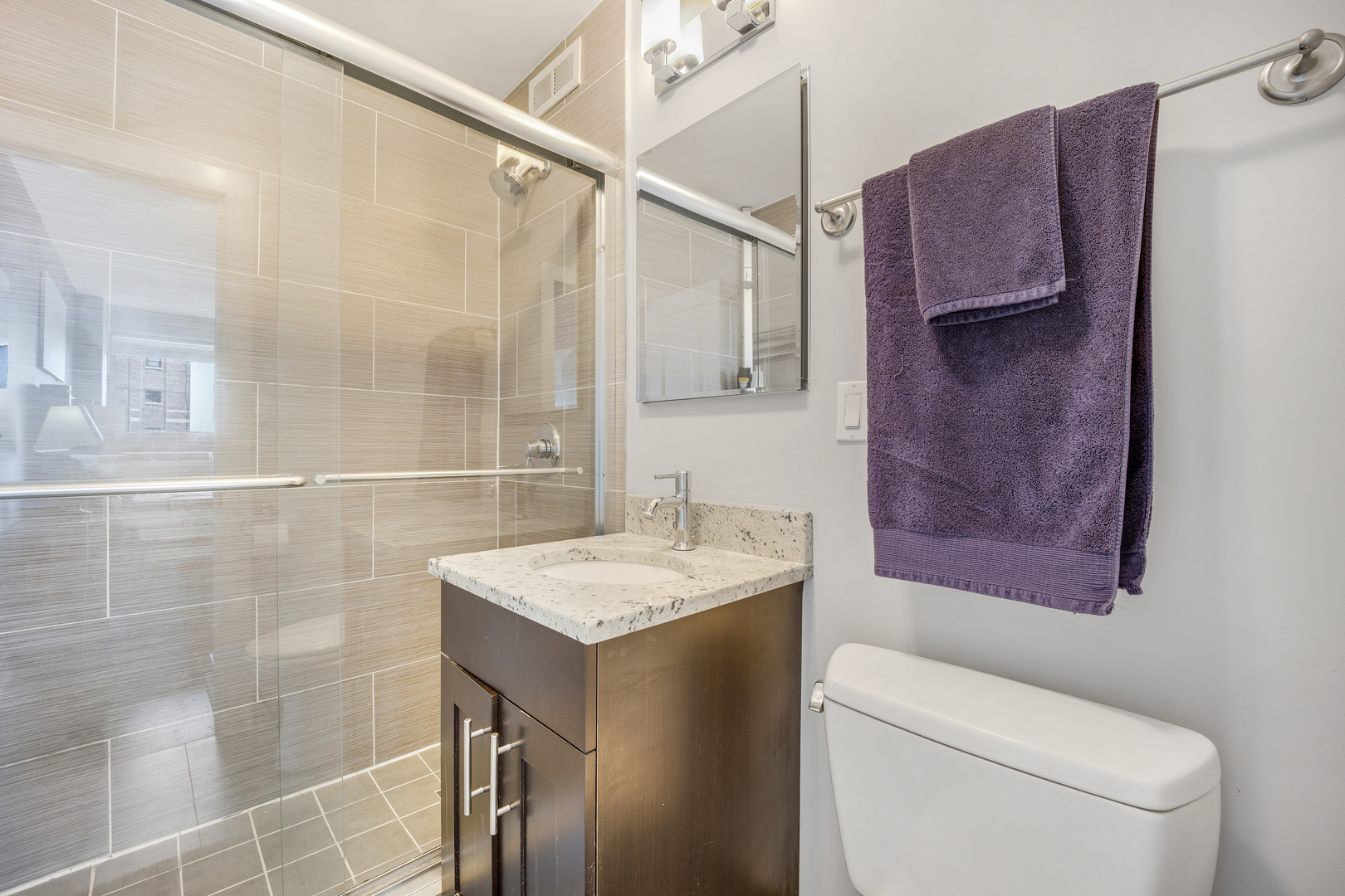2930 North Sheridan Road, Unit 1401 Chicago, IL 60657 - Photo 14 of 23 a bathroom with a sink toilet and shower
