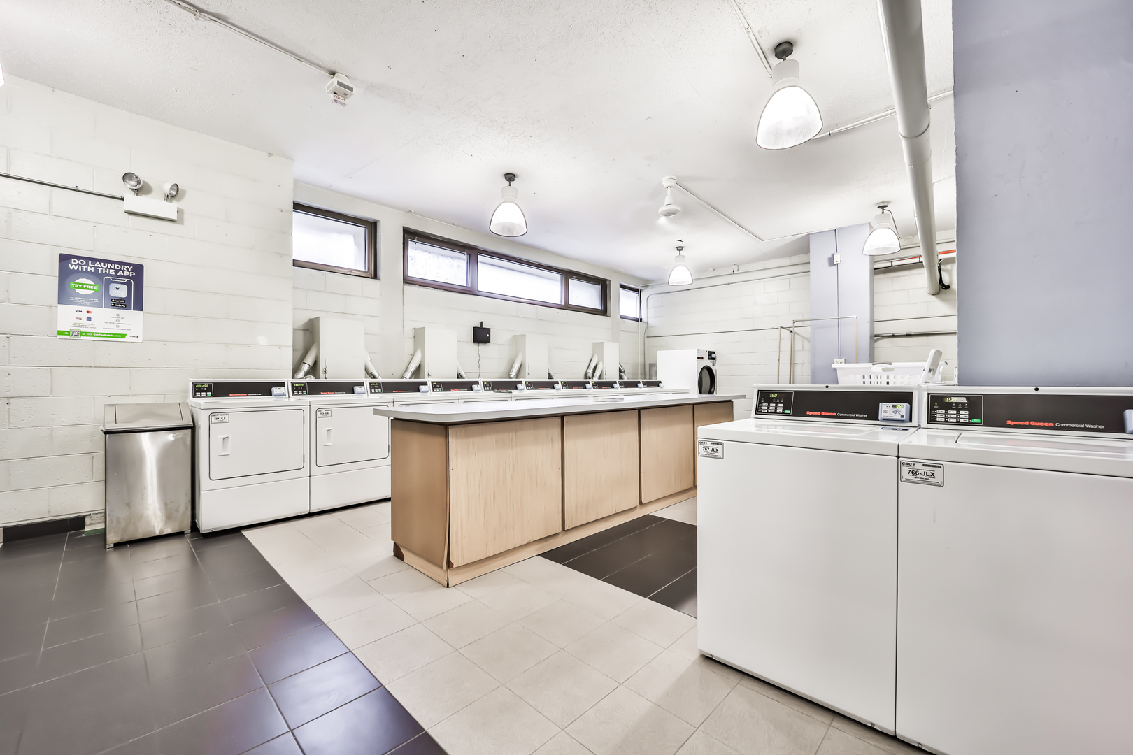 2930 North Sheridan Road, Unit 1401 Chicago, IL 60657 - Photo 20 of 23 a kitchen with stainless steel appliances granite countertop a sink a stove a refrigerator and white cabinets with wooden floor