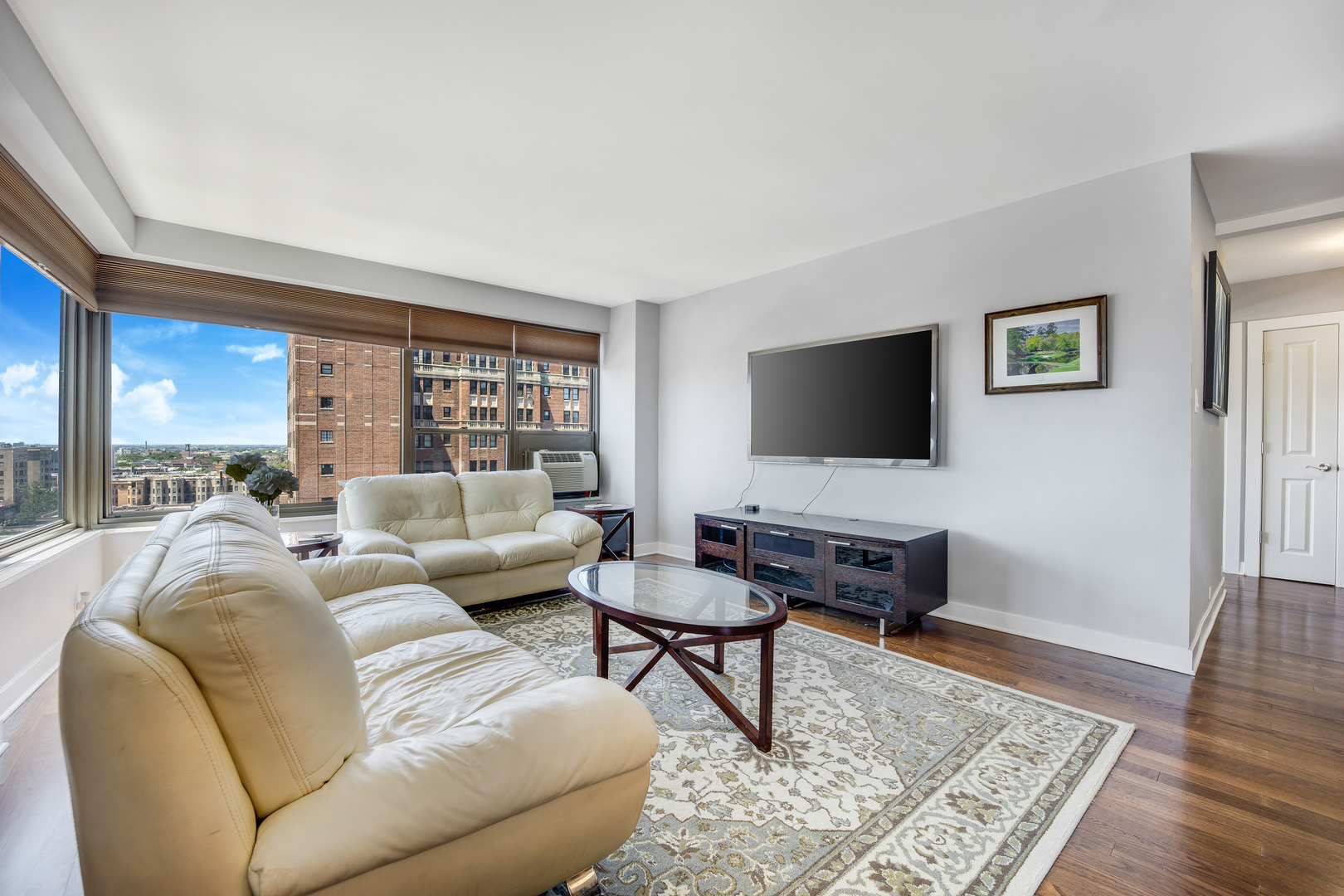 2930 North Sheridan Road, Unit 1401 Chicago, IL 60657 - Photo 3 of 23 a living room with furniture and a flat screen tv