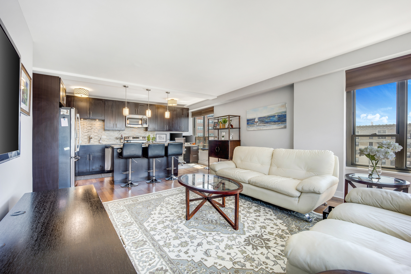 2930 North Sheridan Road, Unit 1401 Chicago, IL 60657 - Photo 4 of 23 a living room with lots of furniture and view of kitchen