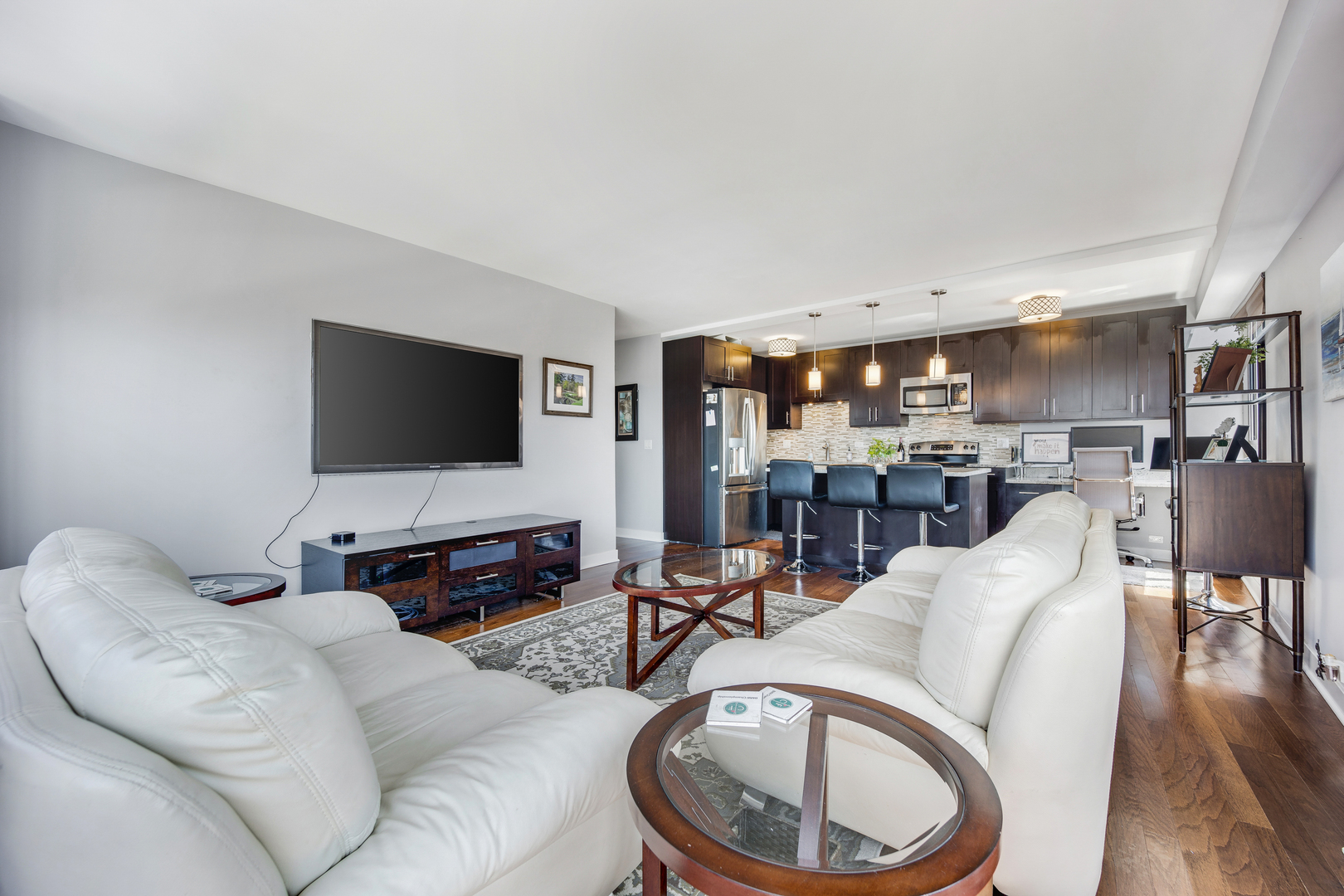 2930 North Sheridan Road, Unit 1401 Chicago, IL 60657 - Photo 5 of 23 a living room with furniture and a flat screen tv