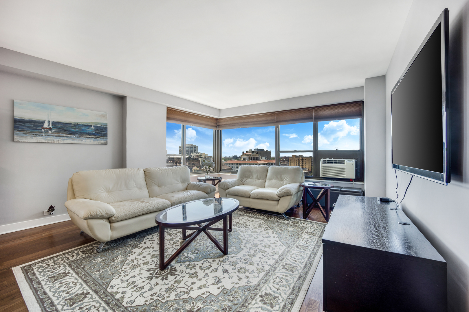 2930 North Sheridan Road, Unit 1401 Chicago, IL 60657 - Photo 6 of 23 a living room with furniture and a flat screen tv