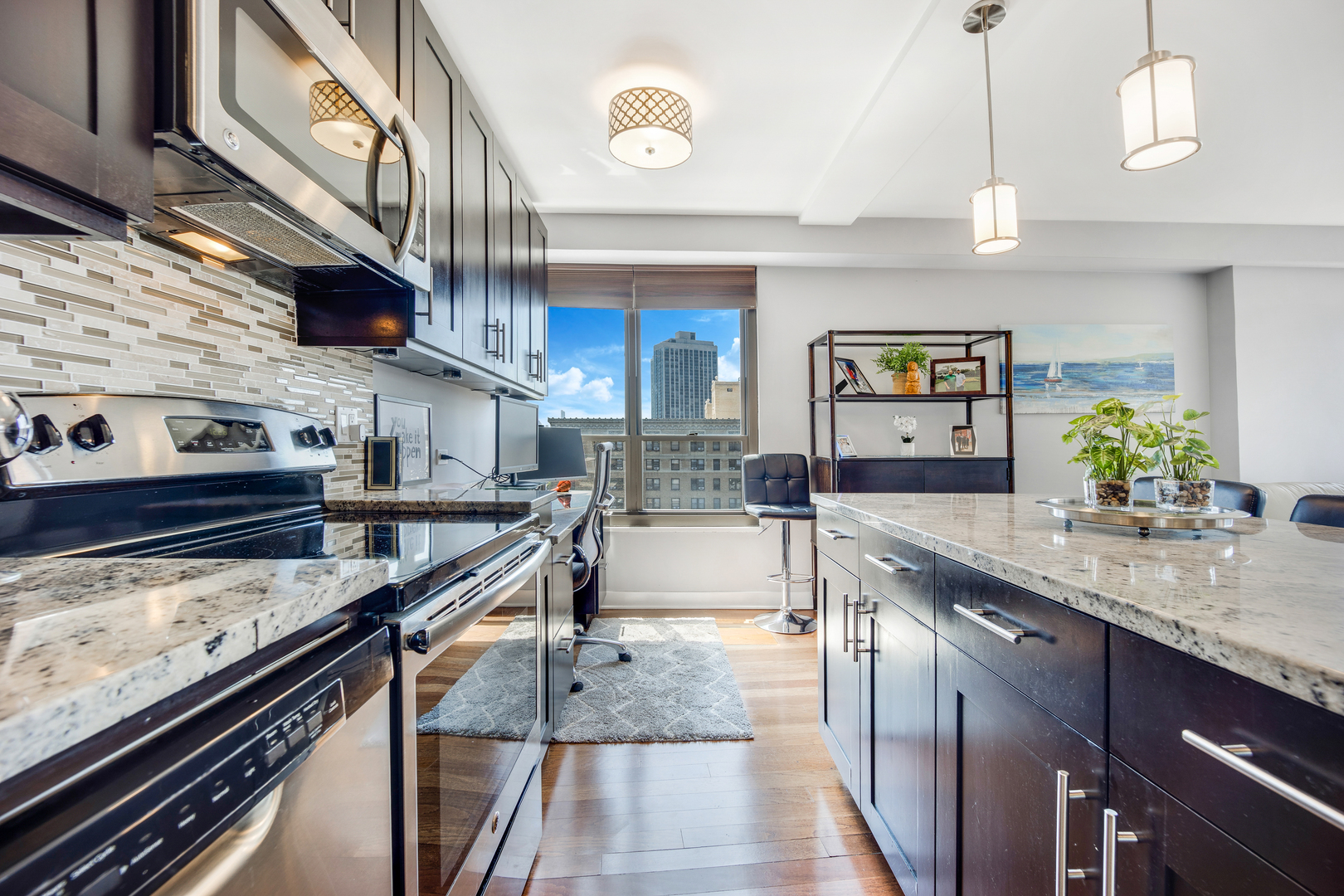 2930 North Sheridan Road, Unit 1401 Chicago, IL 60657 - Photo 7 of 23 a large kitchen with stainless steel appliances granite countertop a stove and a sink