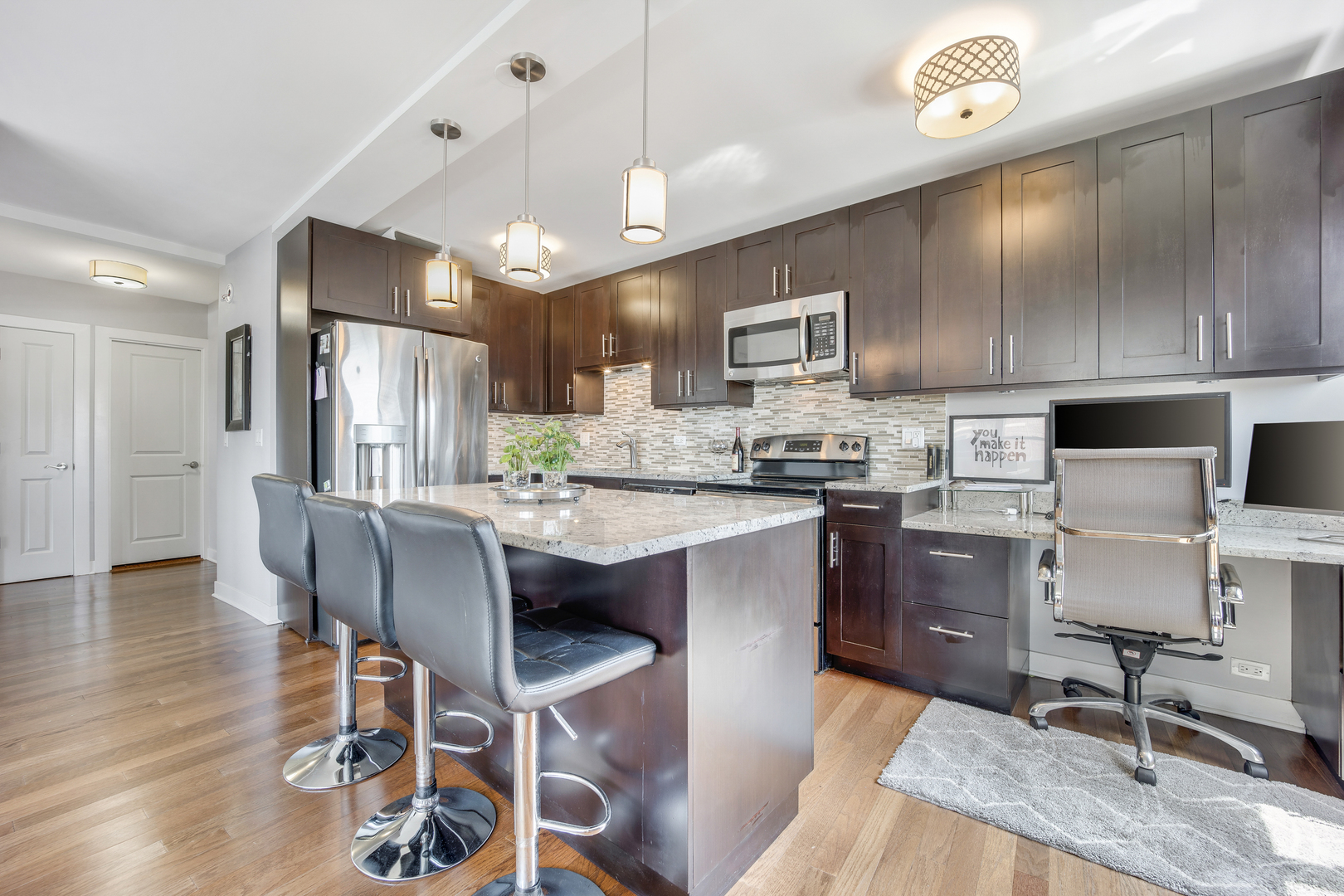 2930 North Sheridan Road, Unit 1401 Chicago, IL 60657 - Photo 8 of 23 a kitchen with kitchen island granite countertop a sink counter top space appliances and cabinets