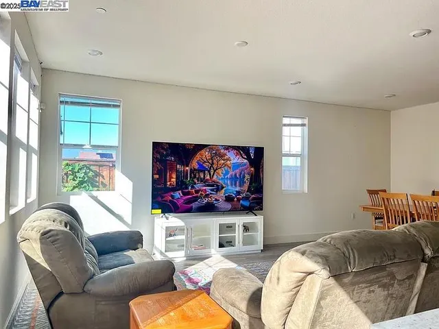 a living room with furniture a couch and a flat screen tv