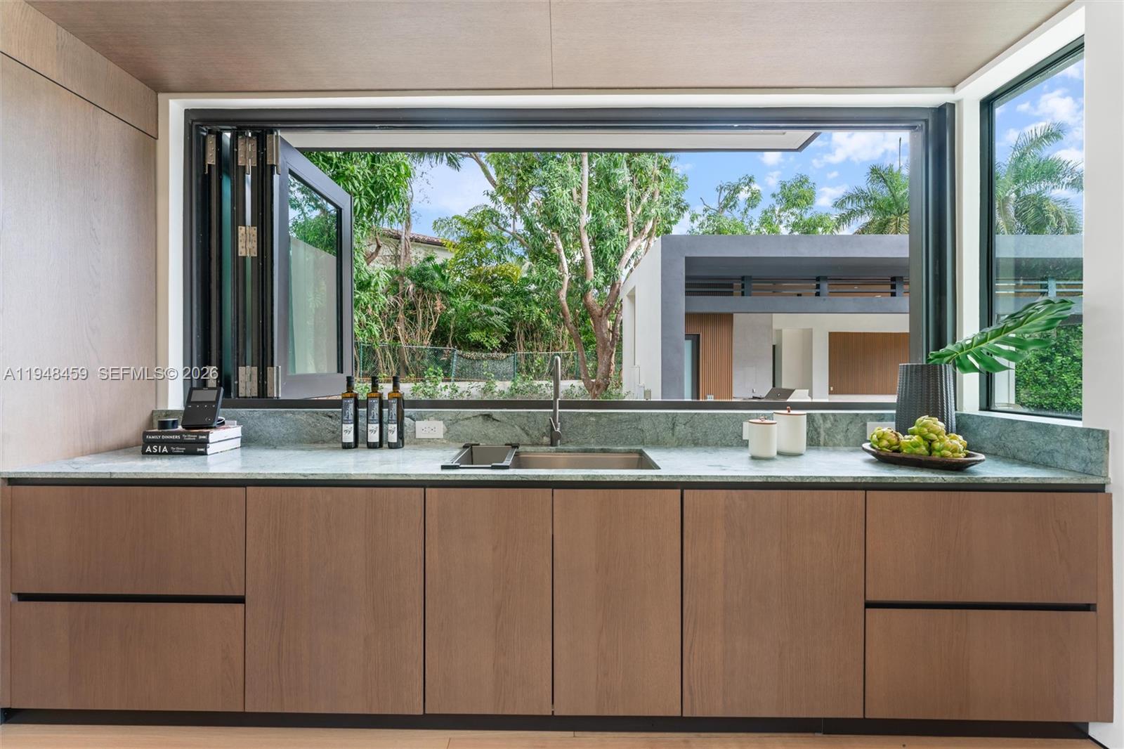 5845 Southwest 130th Terrace Pinecrest, FL 33156 - Photo 13 of 44 a kitchen with a sink and large window