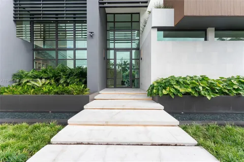 a view of front door with couch and a potted plant