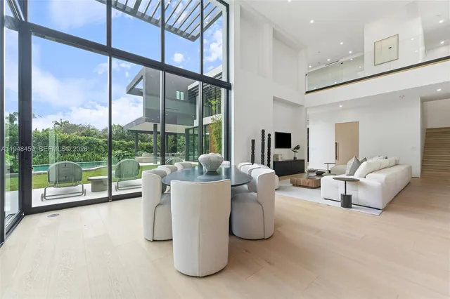 a dining room with large trees and furniture