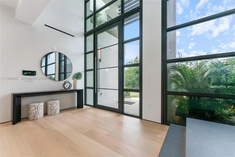 a view of a balcony with floor to ceiling windows with wooden floor