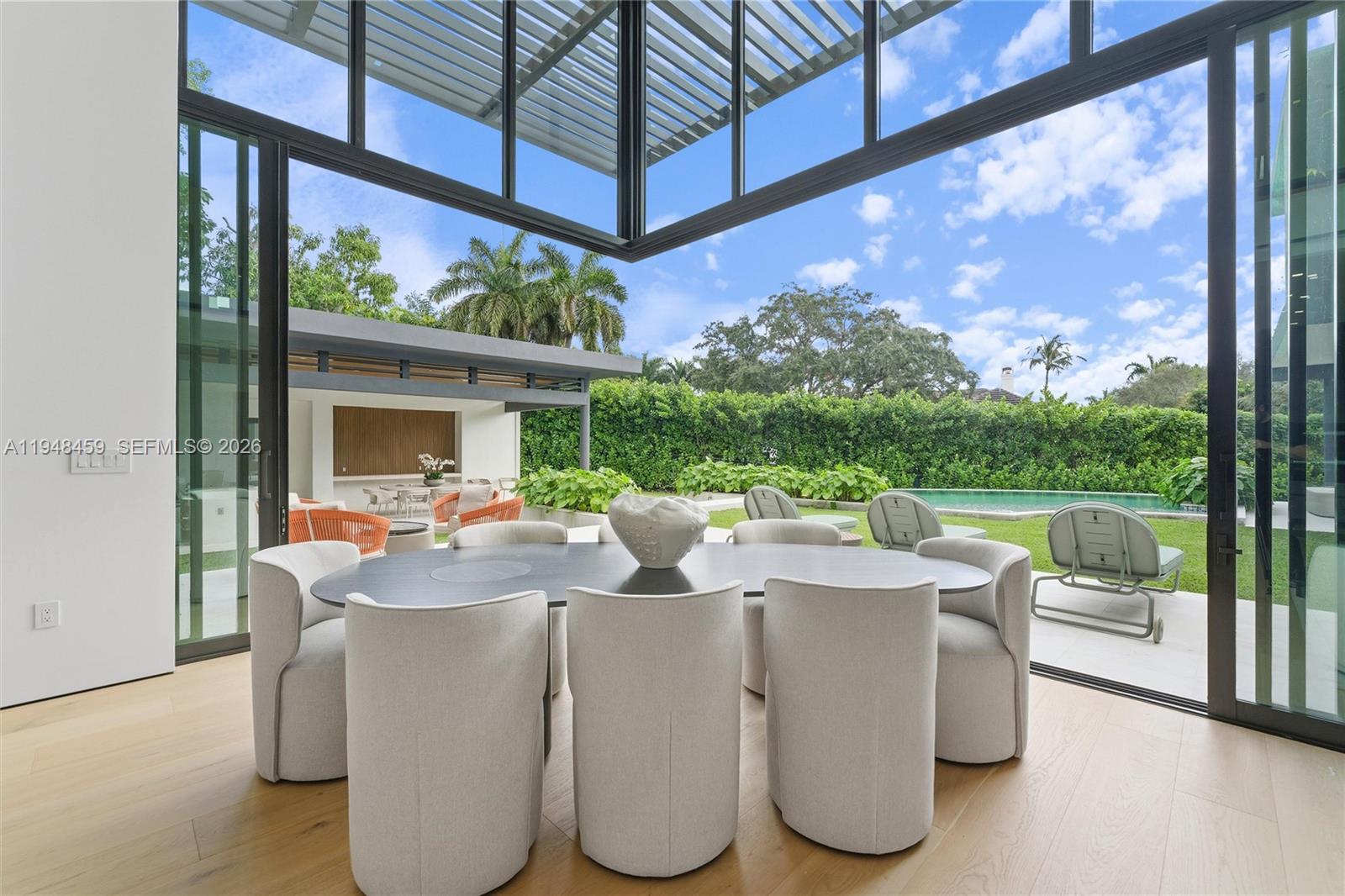 5845 Southwest 130th Terrace Pinecrest, FL 33156 - Photo 16 of 44 a dining room with large trees and furniture