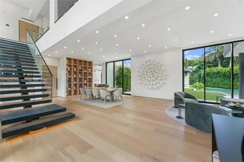 a living room with furniture and large windows