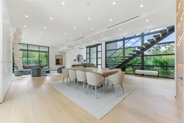 a dining hall with stainless steel appliances granite countertop a table and chairs with the ocean view