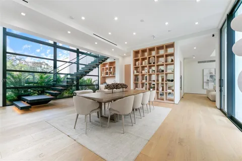 a living room with furniture wooden floor and a large window