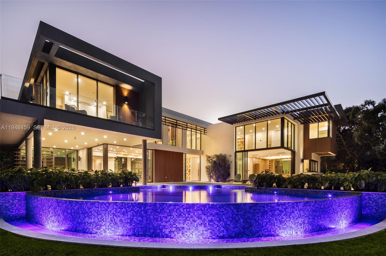 5845 Southwest 130th Terrace Pinecrest, FL 33156 - Photo 2 of 55 a front view of a house with a yard