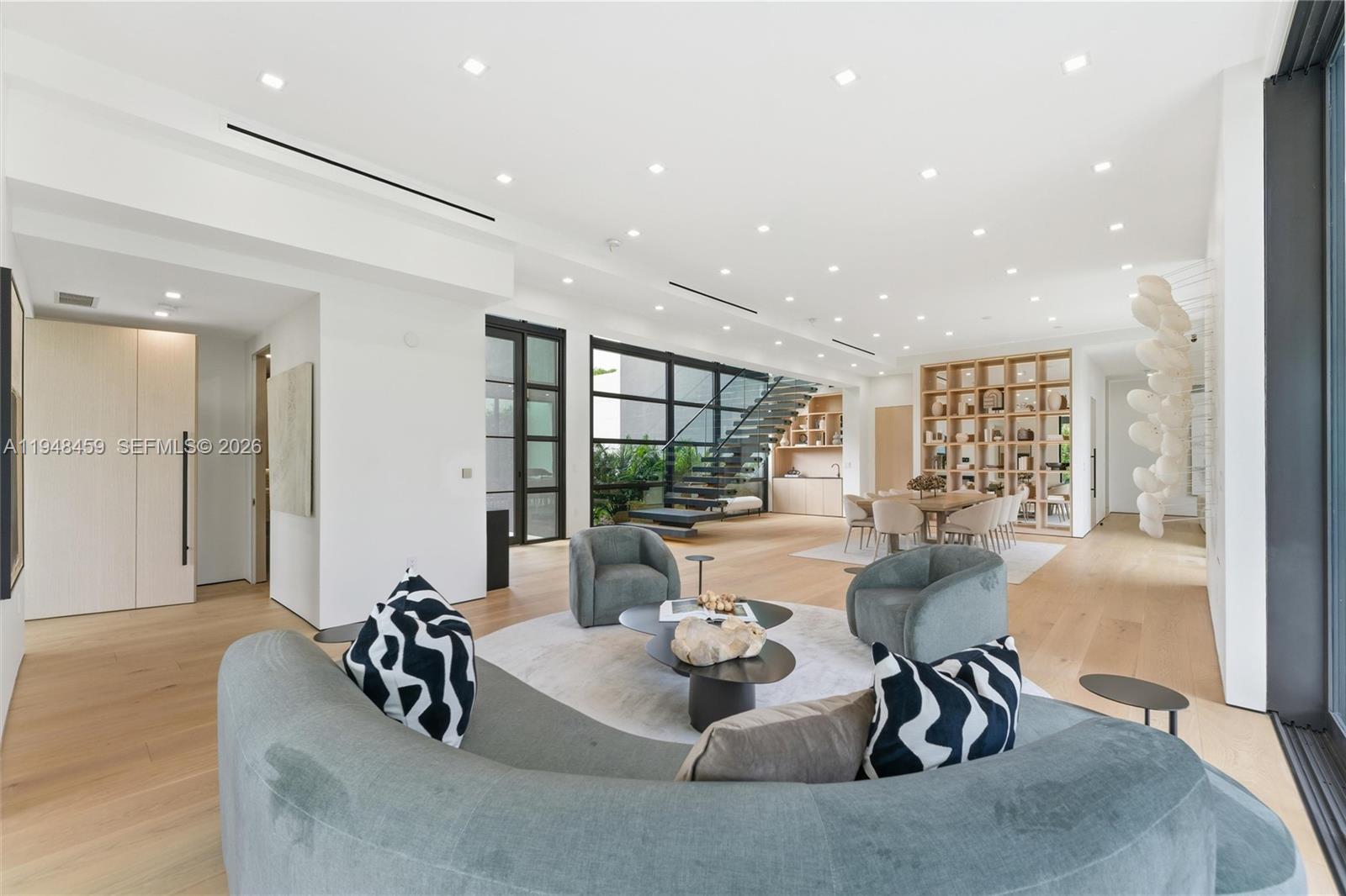 5845 Southwest 130th Terrace Pinecrest, FL 33156 - Photo 21 of 55 a living room with furniture and a large window