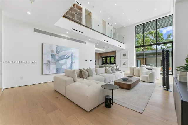 a living room with large flat screen tv and a large window