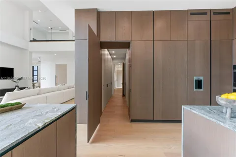 a dining room with large trees and furniture