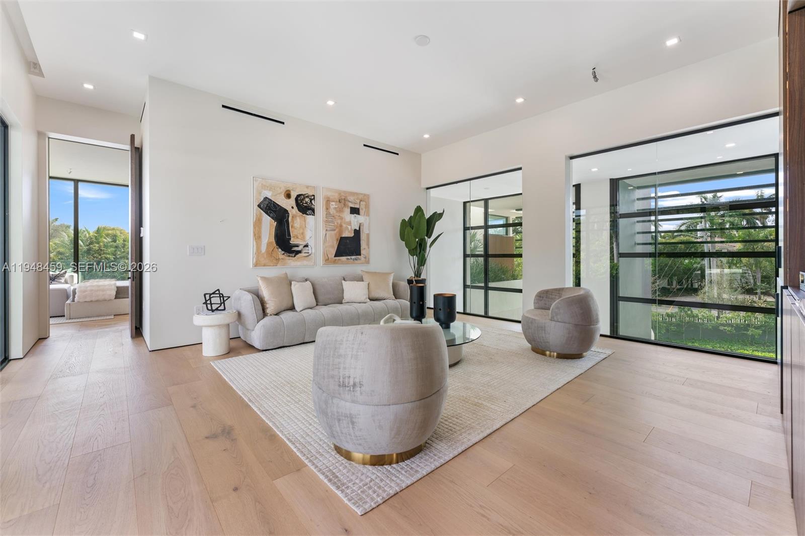 5845 Southwest 130th Terrace Pinecrest, FL 33156 - Photo 30 of 44 a living room with furniture and a wooden floor