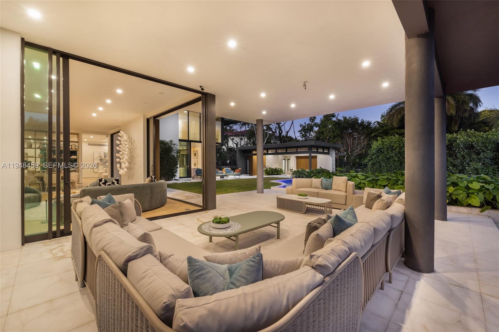 5845 Southwest 130th Terrace Pinecrest, FL 33156 - Photo 3 of 55 a living room with furniture and a large window