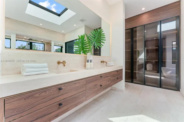 a living room with patio furniture and a potted plant