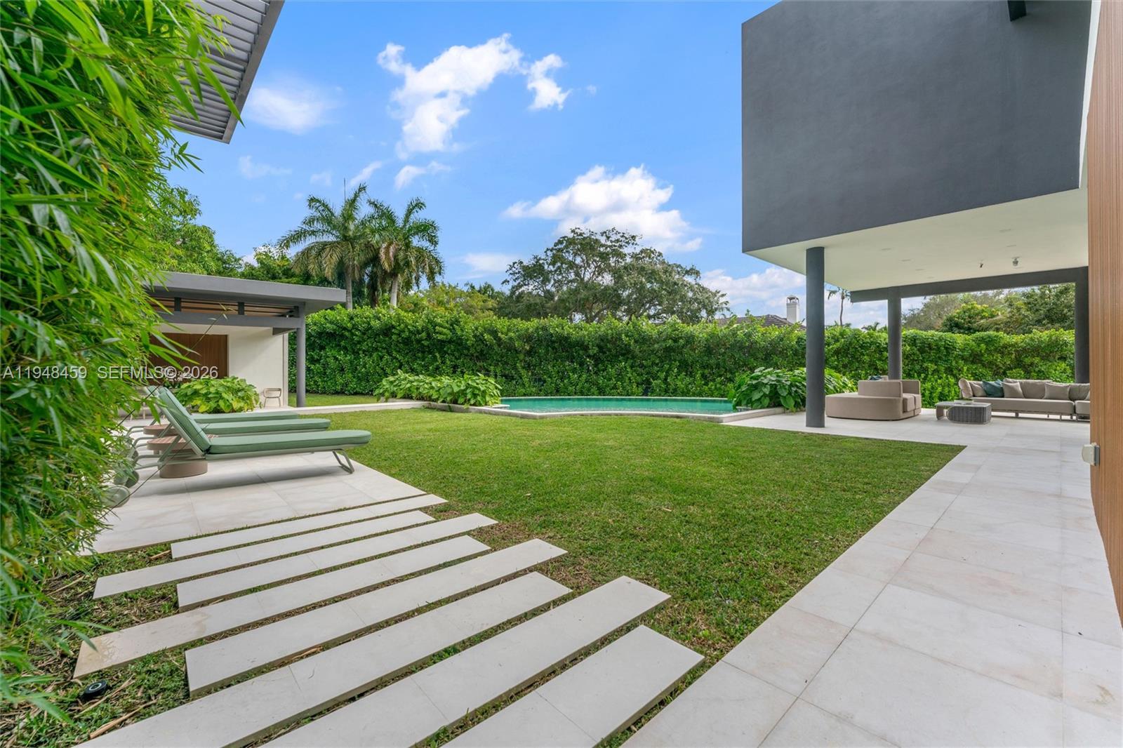 5845 Southwest 130th Terrace Pinecrest, FL 33156 - Photo 39 of 44 a view of a yard with plants and a fountain