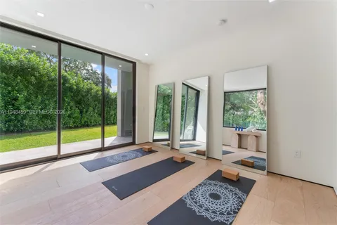 a large bedroom with a large bed and tv with large window