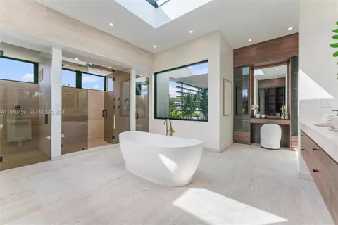 a view of a house with backyard and a tree