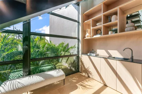 a living room with furniture and large windows