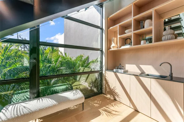 a living room with furniture and large windows