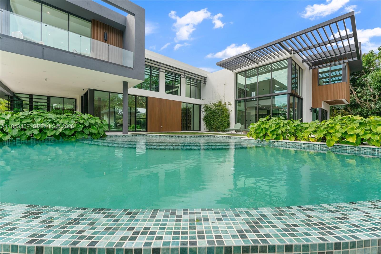5845 Southwest 130th Terrace Pinecrest, FL 33156 - Photo 55 of 55 a front view of a house with a yard