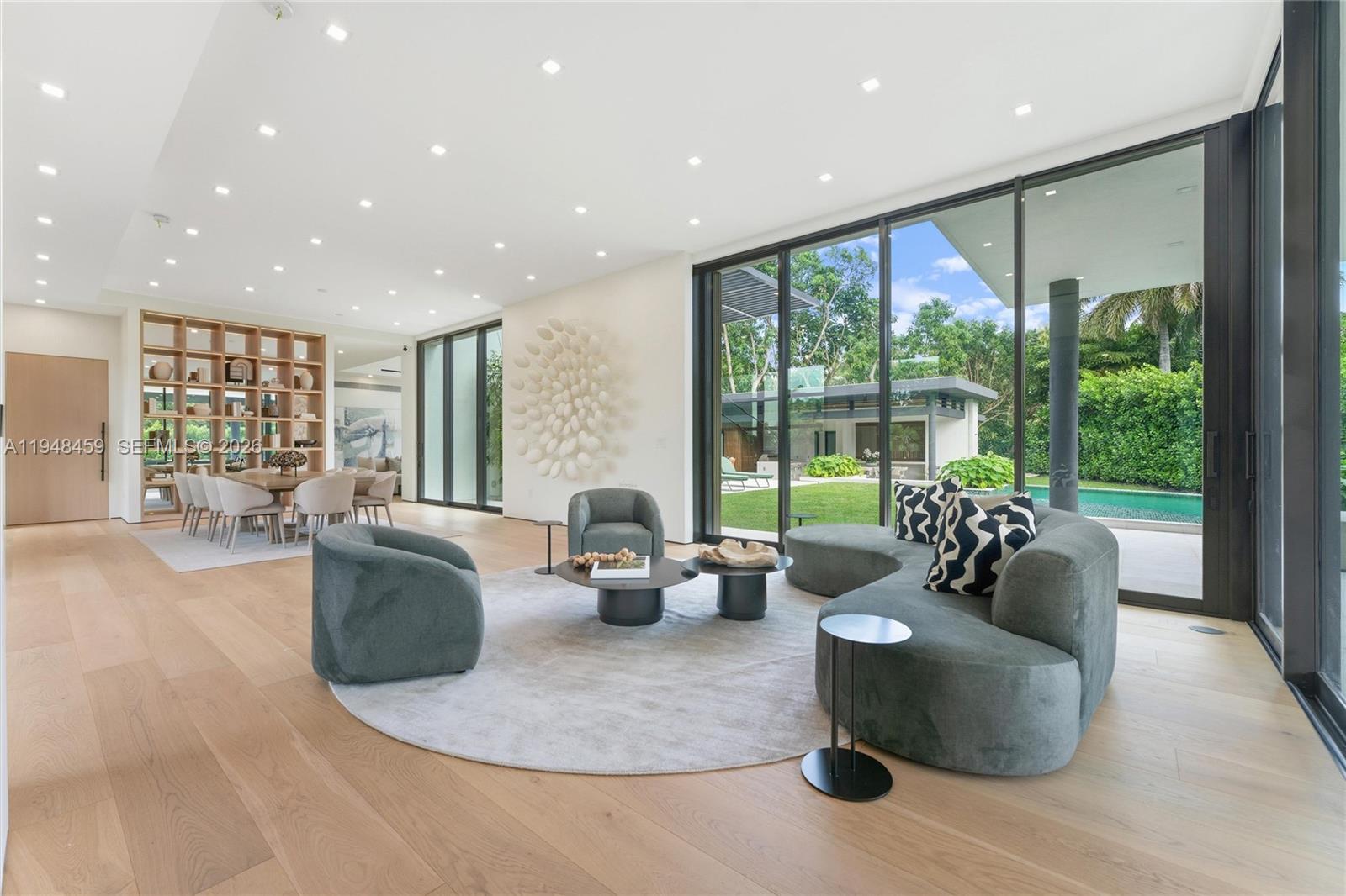 5845 Southwest 130th Terrace Pinecrest, FL 33156 - Photo 6 of 44 a living room with furniture and large windows