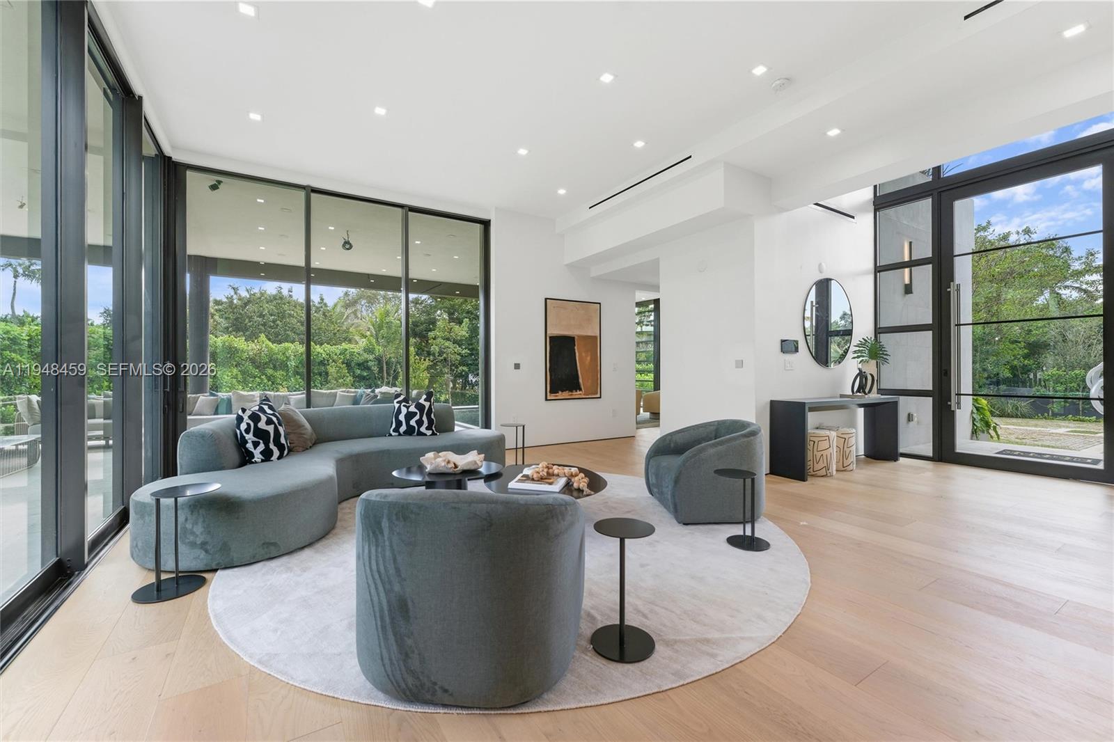 5845 Southwest 130th Terrace Pinecrest, FL 33156 - Photo 7 of 44 a living room with furniture and a large window