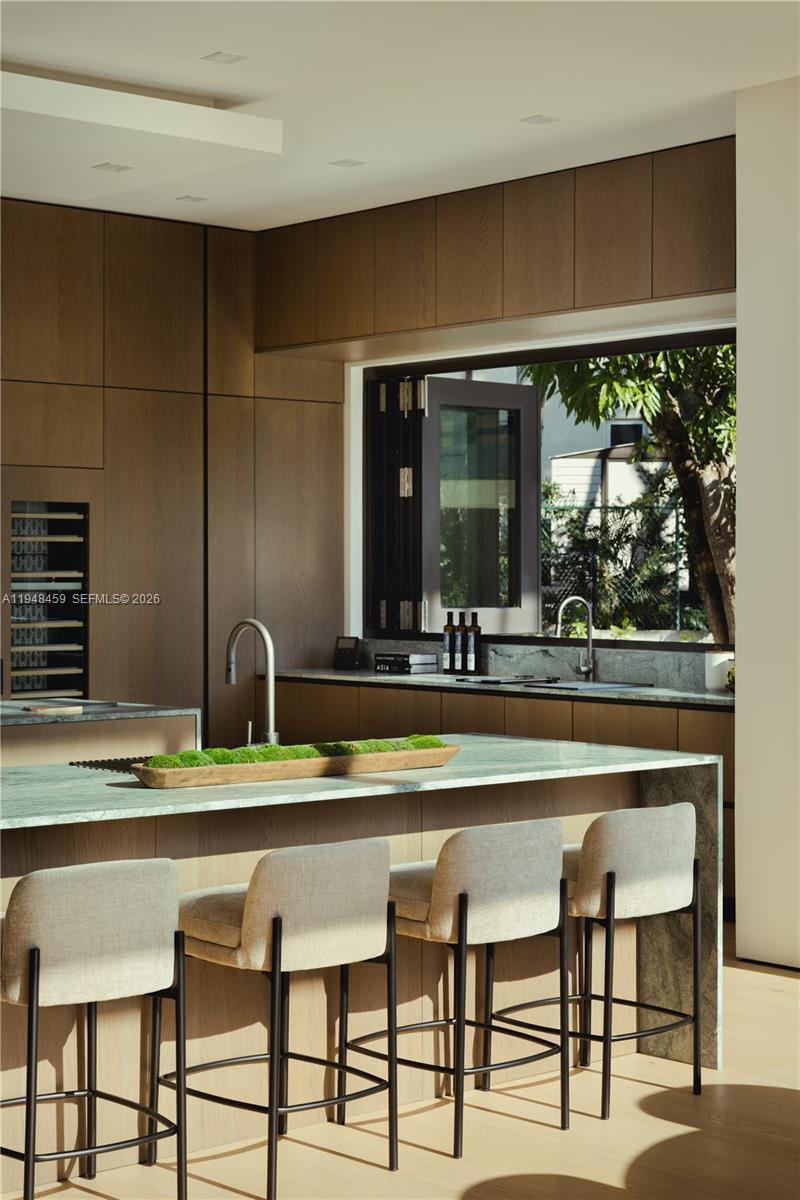 5845 Southwest 130th Terrace Pinecrest, FL 33156 - Photo 7 of 55 a bathroom with a sink and a large mirror