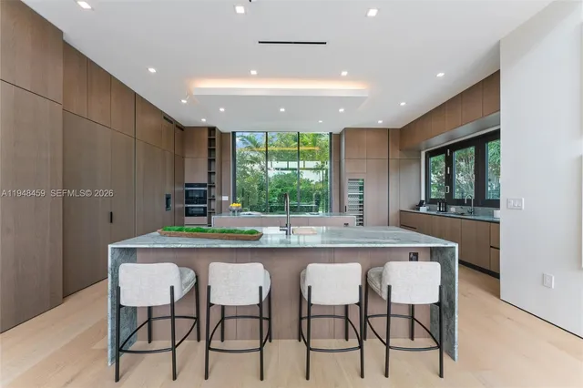 a kitchen with a table chairs refrigerator and chairs