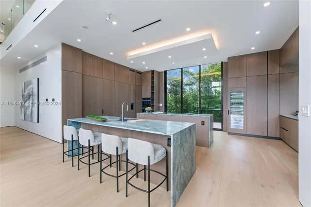 a kitchen with kitchen island a large island in it