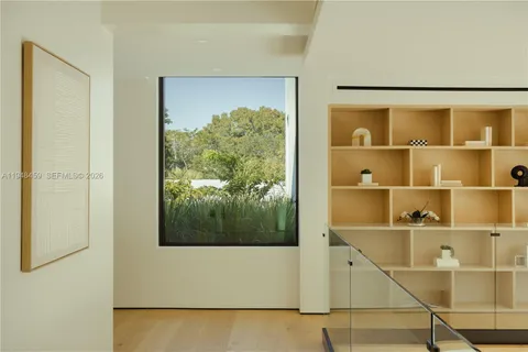 a bedroom with furniture and a large window