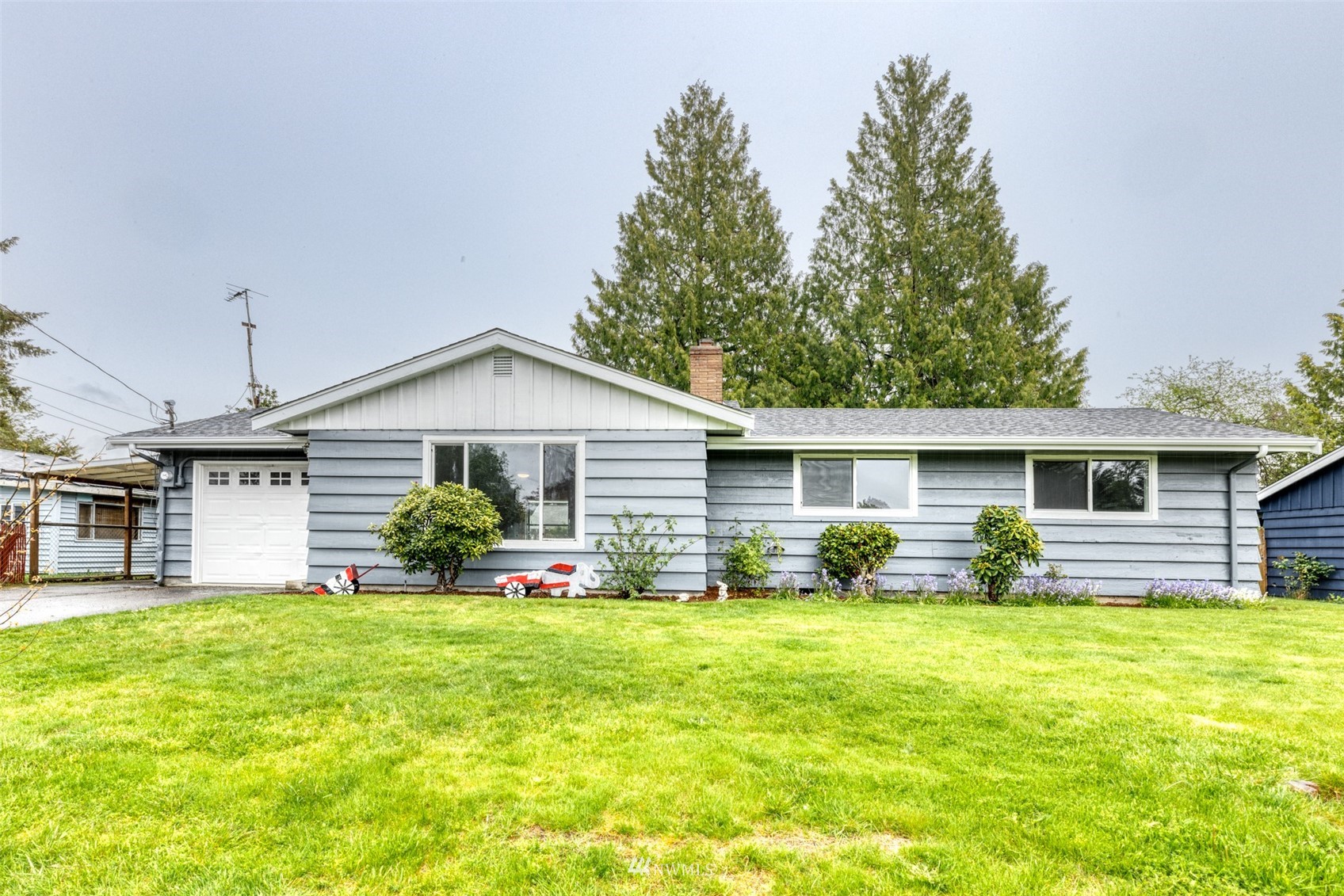 a front view of house with yard and green space