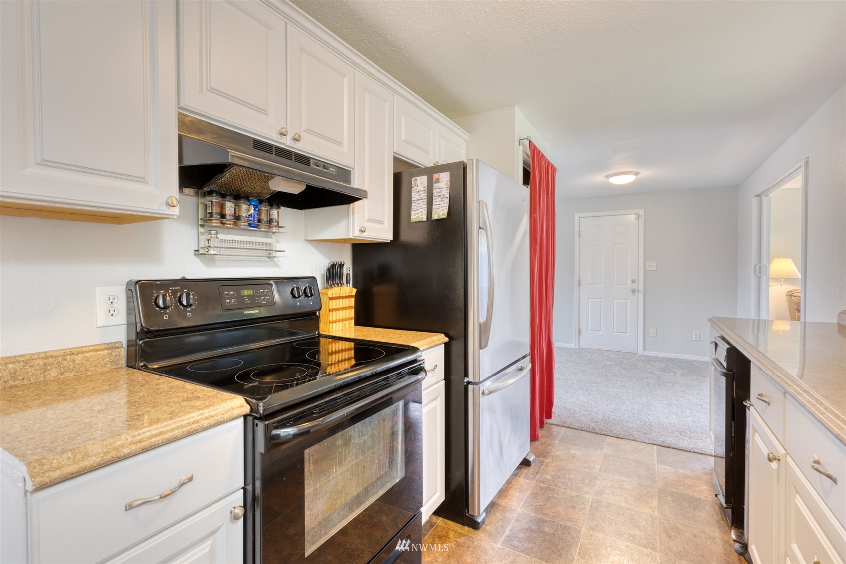 8705 Terrace Road Southwest Lakewood, WA 98498 - Photo 14 of 28 a kitchen with stainless steel appliances granite countertop a stove a sink and a microwave