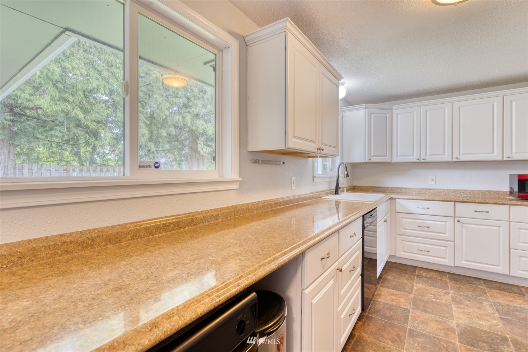 8705 Terrace Road Southwest Lakewood, WA 98498 - Photo 15 of 28 a kitchen with a sink stove and cabinets