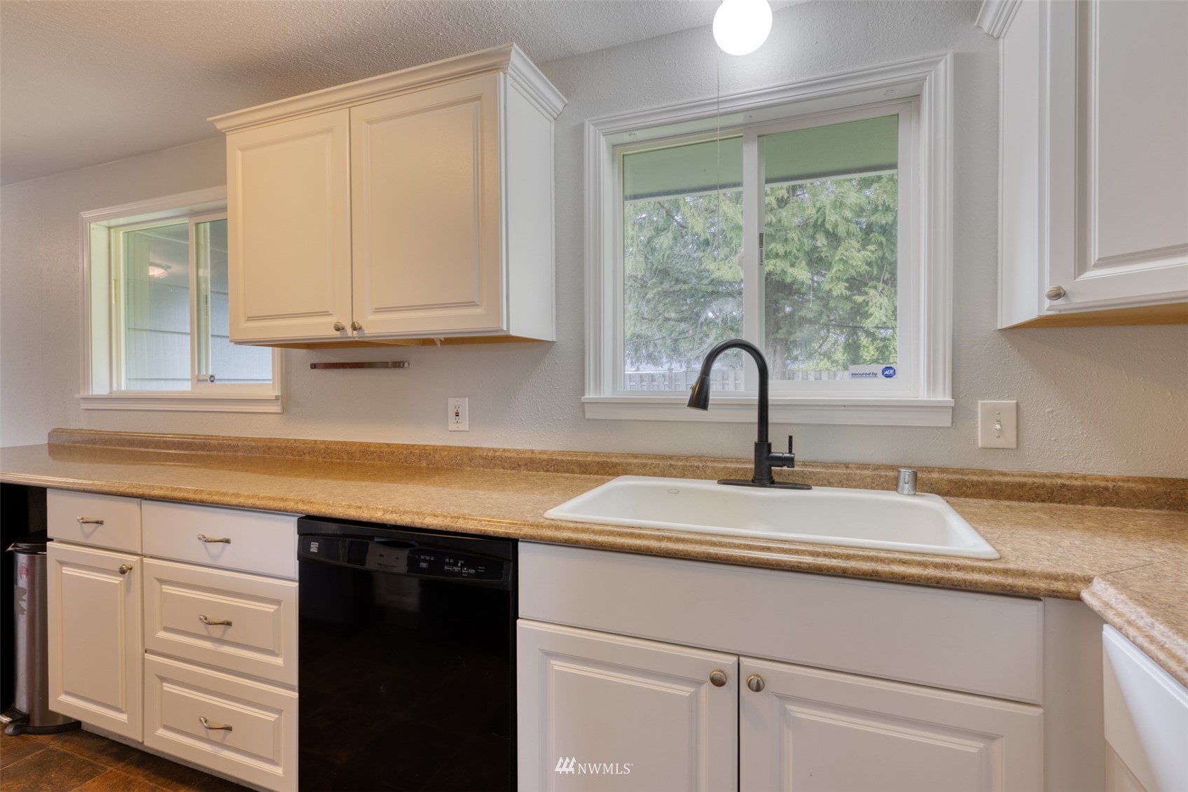 8705 Terrace Road Southwest Lakewood, WA 98498 - Photo 16 of 28 a kitchen with granite countertop white cabinets and a sink